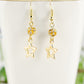 Close up of Sparkly Rhinestone and Gold Star Earrings.