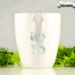 Long Silver Plated Chain and Aquamarine Crystal Chip Earrings on a mug