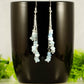 Long Silver Plated Chain and Aquamarine Crystal Chip Earrings on a mug
