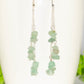 Long Silver Plated Chain and Green Aventurine Crystal Chip Earrings on a mug