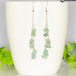 Long Silver Plated Chain and Green Aventurine Crystal Chip Earrings on a mug