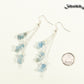 Long Silver Plated Chain and Aquamarine Crystal Chip Earrings beside a dime