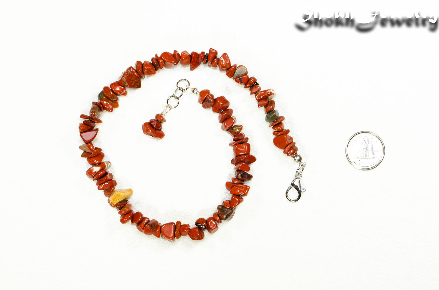 Natural Red Jasper Crystal Chip Anklet beside a dime.