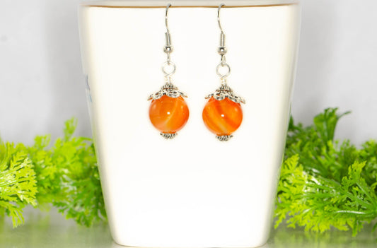 12mm Natural Carnelian Crystal Earrings on a tea cup